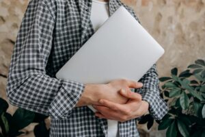 a man holding a laptop to learn Cybersecurity