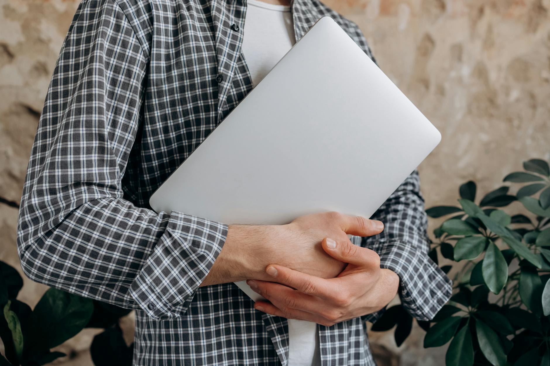 a man holding a laptop to learn Cybersecurity