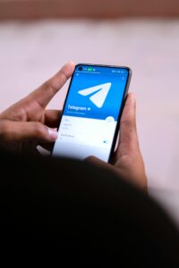 man showing telegram on phone